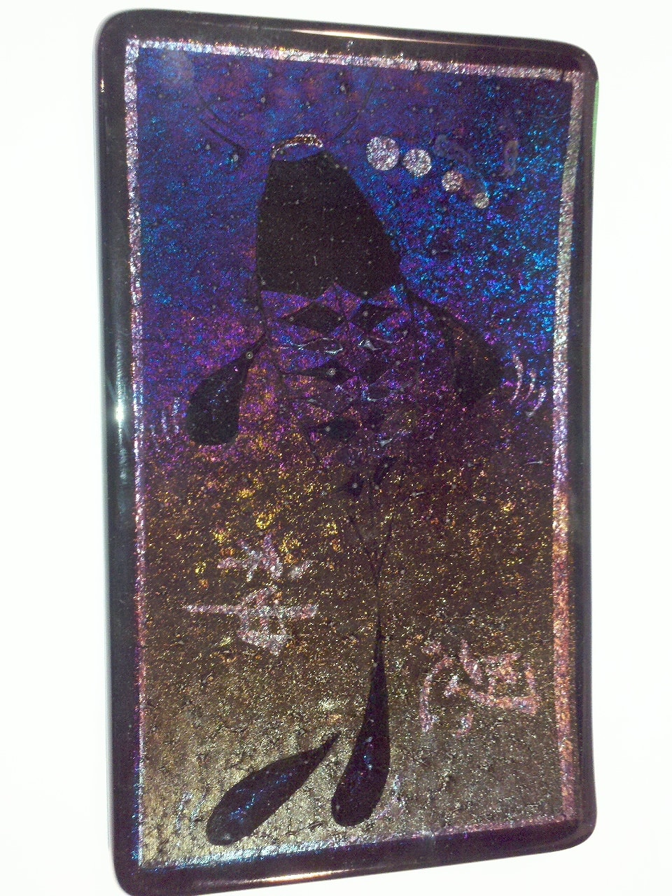 Irid koi fish silhouette in deep black on a shimmering iridescent background shifting from blue-purple to bronze-gold.