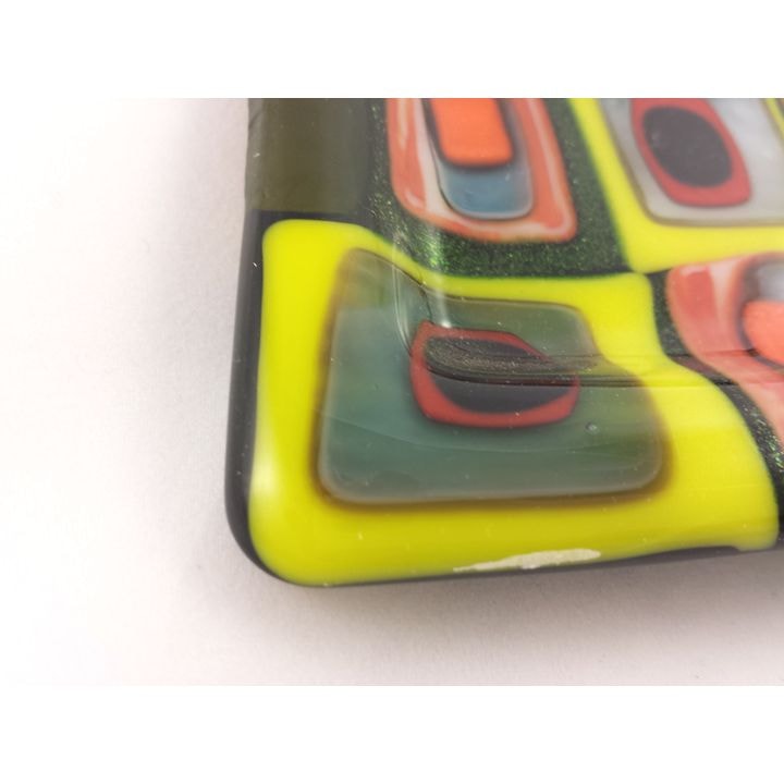 Closeup of stacked glass showing reaction line between yellow and green